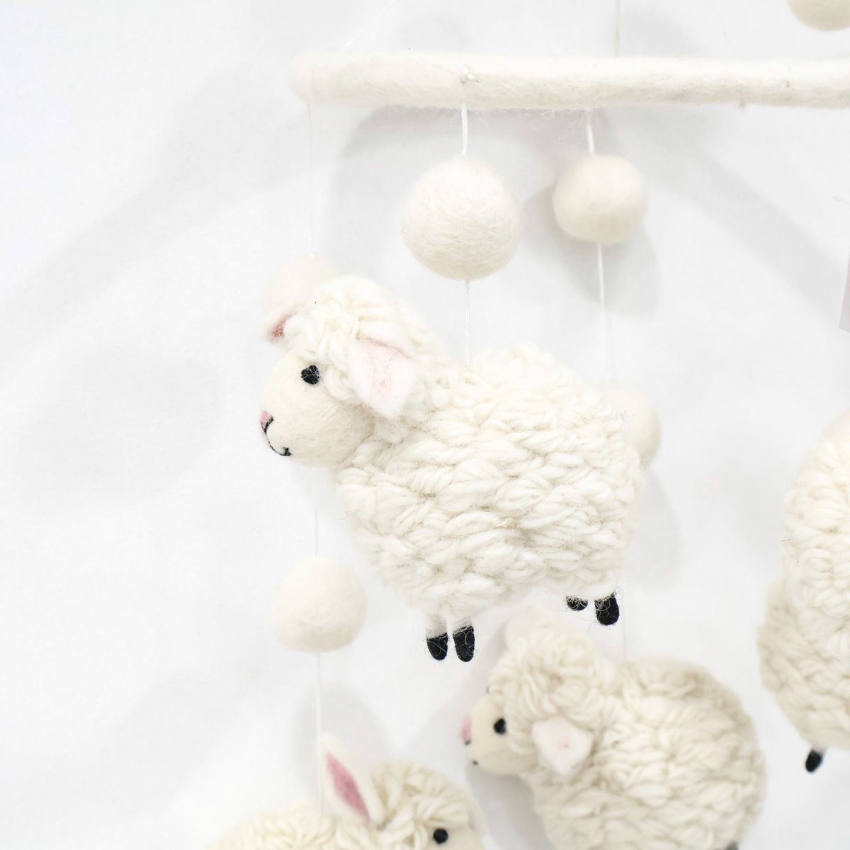 Cute handmade baby mobile with soft white lambs, eco-friendly wool nursery decoration, made in Nepal