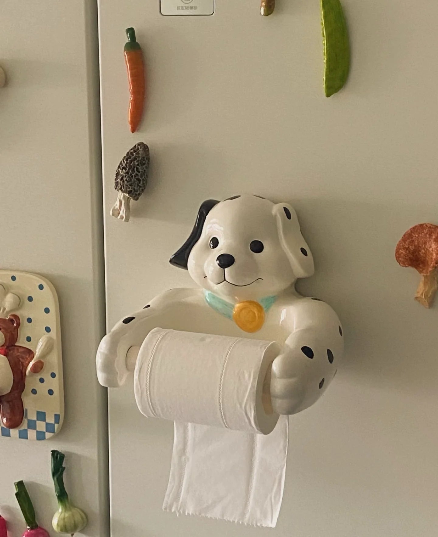 Front view of cute spotted dog toilet roll holder
