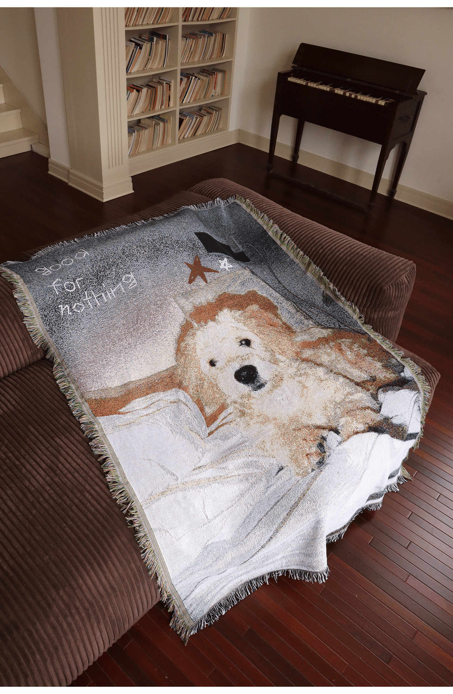 Golden retriever illustrated blanket displayed on a sofa
