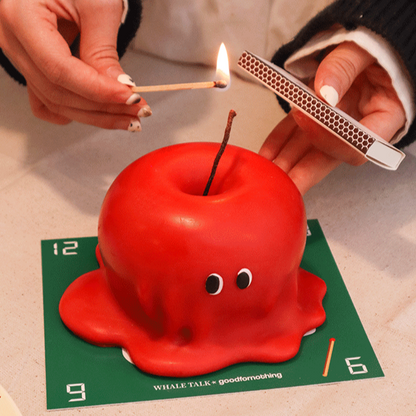 Cute red melted apple shaped candle with eyes, includes gift box and scent card
