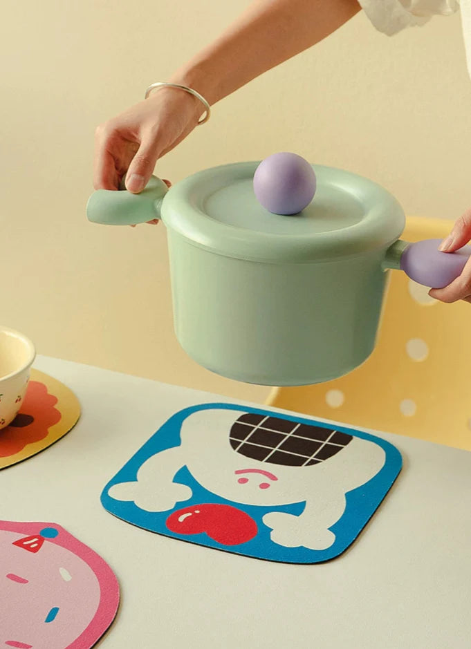 Hand holding cookie-shaped mat showing size and softness