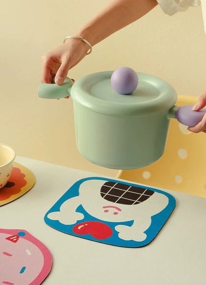 Hand holding cookie-shaped mat showing size and softness