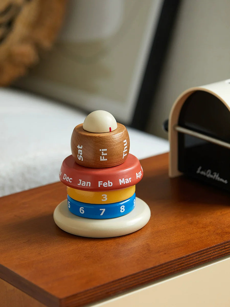 Hand rotating a wooden desk calendar for date adjustment
