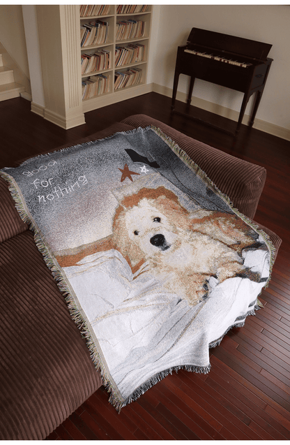 Golden retriever illustrated blanket displayed on a sofa