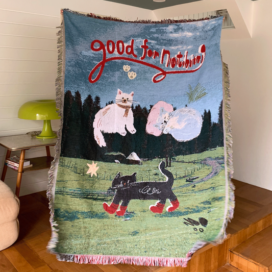 g
Knitted cat illustration blanket on green field background
