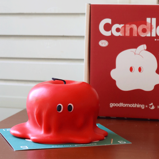 Cute red melted apple shaped candle with eyes, includes gift box and scent card