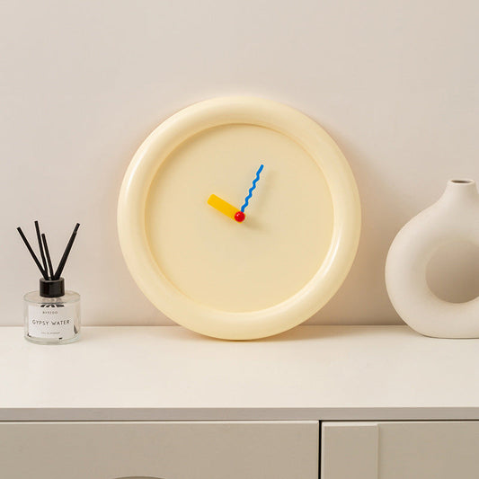 Cream color round wall clock with colorful wavy hands