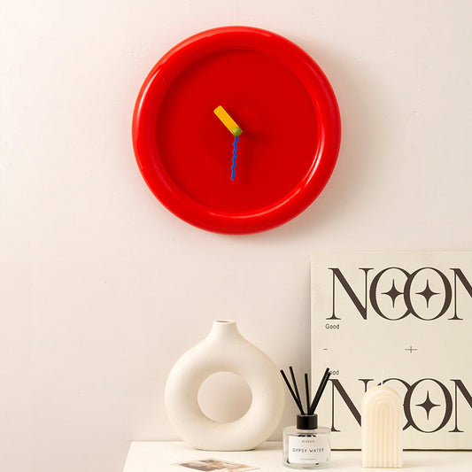 Round wall clock on minimalist cabinet in bright home interior
