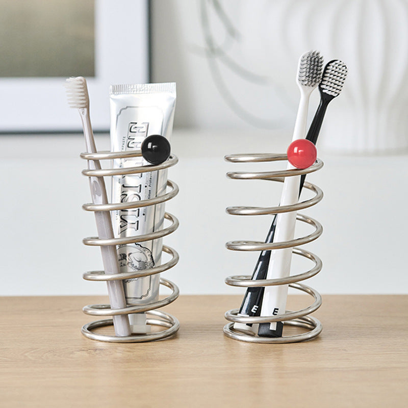 Stainless steel spiral holder with red ceramic ball used for toothbrush or pen storage