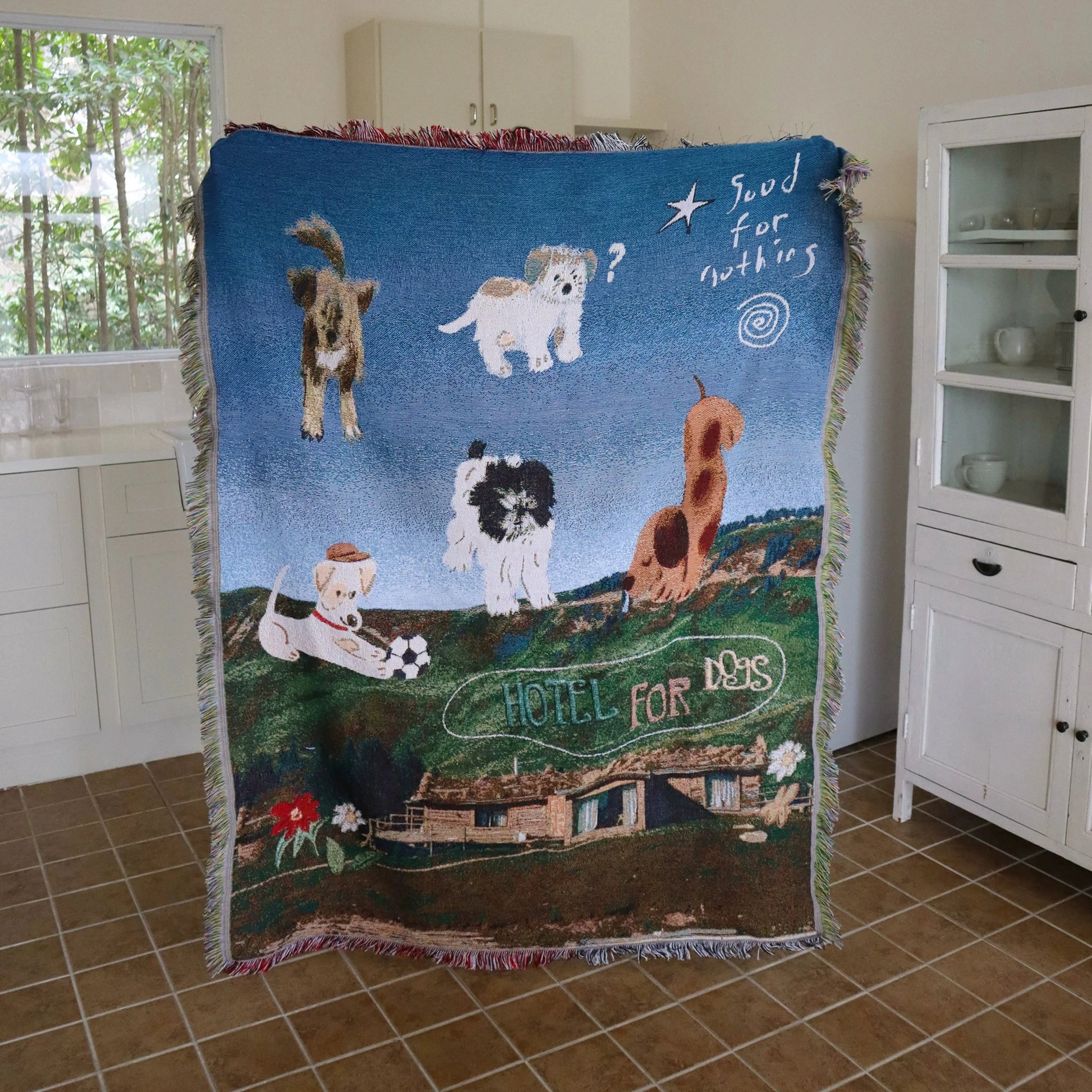 Knitted blanket with dog illustrations laid out fully
