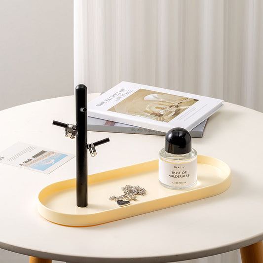 Minimalist Nordic-style cream jewelry tray with one black tree hook